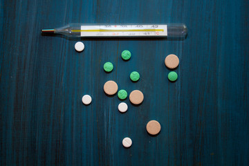 medical background pills and a thermometer, place for text