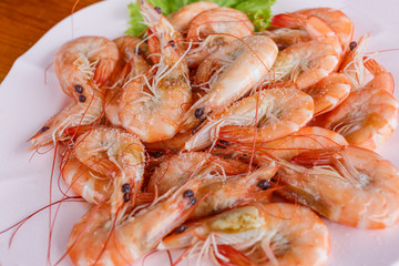 Baked butter shrimp on white dish