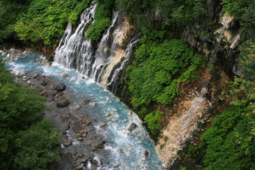 Fototapeta na wymiar Biei waterfall of Shirahige of summer