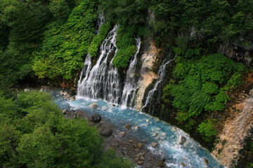 Fototapeta na wymiar Biei waterfall of Shirahige of summer