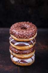 Donuts in colored glazes on a dark background.Pastries,dessert.selective focus.