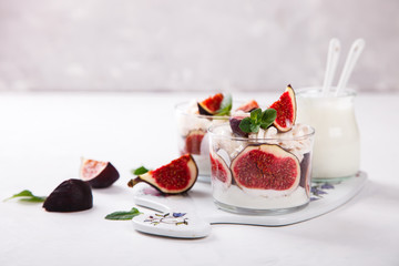 Eton Mess. Fresh figs with whipped cream and meringue in a glass beaker. Dessert.Meringue from egg whites. selective focus