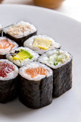 various of maki sushi on white plate