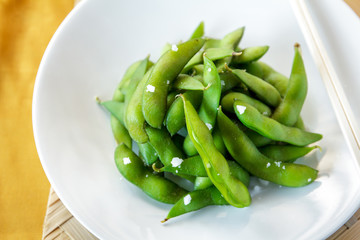 japanese food edamame nibbles, boiled green soy beans