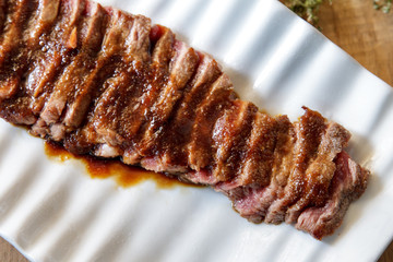 japanese food wafu steak served on white plate with soy sauce, w