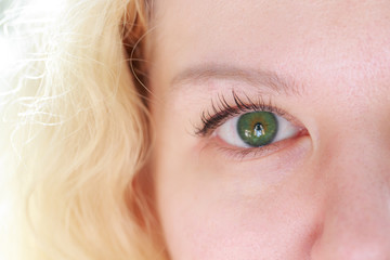Beautiful green eye of blonde close.