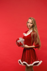 girl on a red background holds  gift box