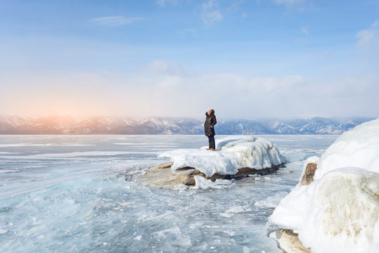 girl on the glacier of lake Baikal during winter