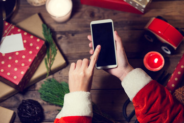 Santa use smart phone mock up with a copyspace for Christmas.Chr