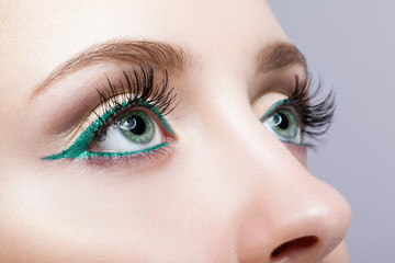 female eye zone and brows with evening green eyeliner makeup