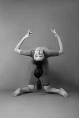 attractive woman dancer on gray background, monochrome image