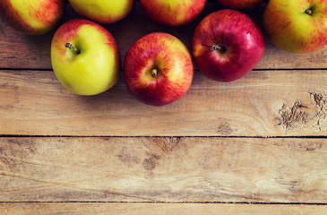 red apple on wood background texture with space for text