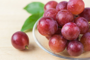 purple round grapes on old wooden table