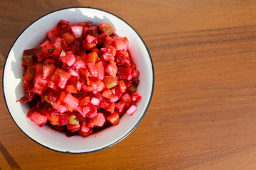 Russian beet salad vinaigrette in rustic bowl on wooden table