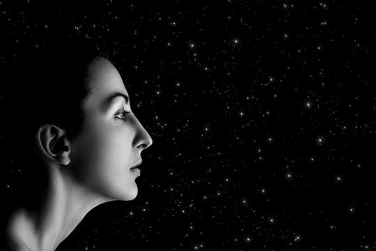serious female profile on stars sky background with copyspace