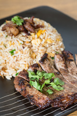 The sliced grilled steak with fried rice