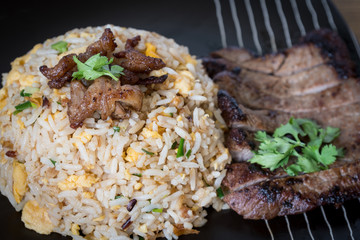 A close up shot of sliced grilled steak with  fried rice
