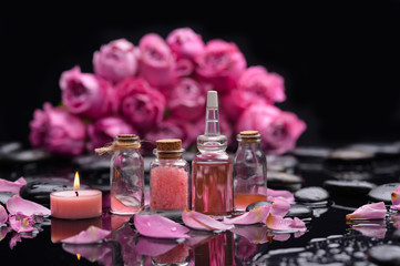 Still life with pink rose with candle and therapy stones 	