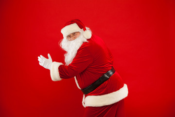 Running Santa Claus red background Merry Christmas.