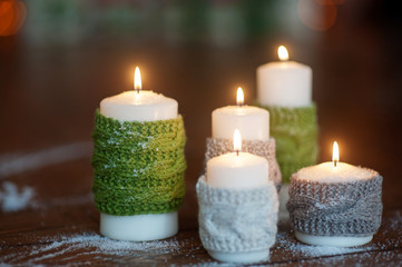 Obraz na płótnie Canvas Christmas candles with knitted covers and other decorations