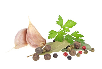 Dried bay laurel leaves, parsley, garlic and peppercorns isolate