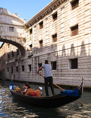 Fototapeta na wymiar Gondolier under the Bridge of Sighs in Venice
