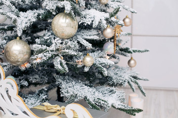 Beautiful holdiay decorated room with Christmas tree with presents under it