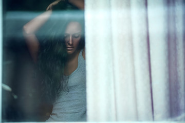 Fototapeta na wymiar Sensual portrait of a beauty brunette model outside the window.
