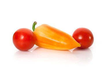 Sweet peppers and tomatoes on white background
