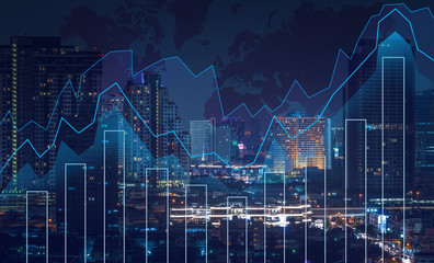 Trading graph on the cityscape at night and world map background