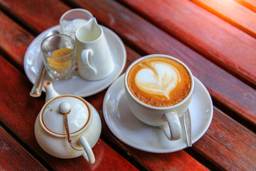 Coffee latte art on the wood desk at coffee shop
