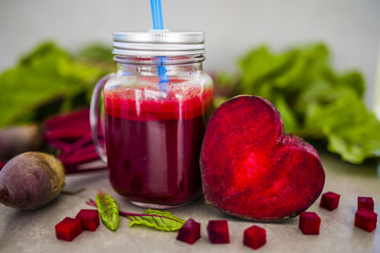 Beetroot juice in a mason jar mug on grey stone background. Detox and healthy diet.