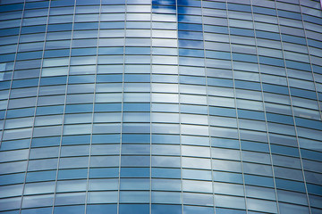 Fototapeta na wymiar wall glass skyscraper with reflection of the sky at night.