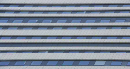 wall glass skyscraper with reflection of the sky at night.