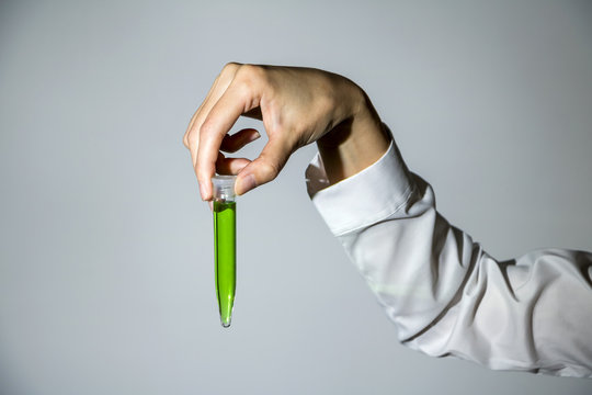 hand holds test tube