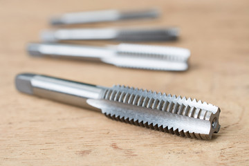 Screw tap cutting tool and broach on wood table