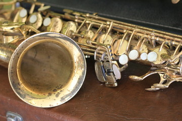 Vintage saxophone on retro texture background.