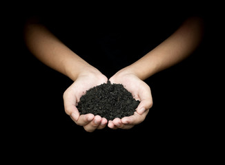 Hands of women holding soil in nature on dark black background 5