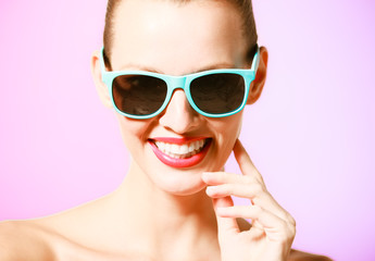 Fototapeta premium Portrait of happy girl wearing sunglasses. 
