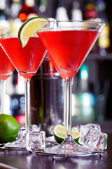 Cosmopolitan cocktails shot on a bar counter in a nightclub. Low