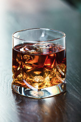 Whiskey on the rocks on a table. Shallow depth of field.