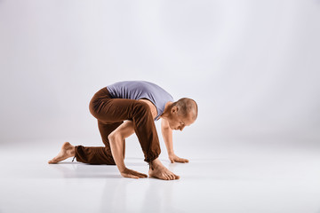Man doing yoga isolated on white background