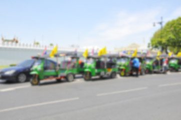 Blurred background : Traveler in the three-wheeler(Tuk-Tuk) travel around the Bangkok,Thailand