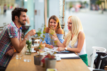 Group of young people laughing in cafe
