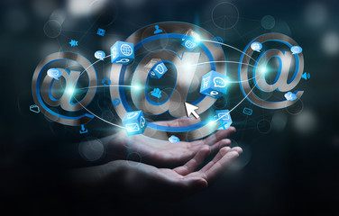 Businessman holding 3D rendering email icon in his hand