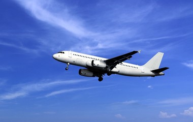 Fototapeta na wymiar Passenger airplane take off under cloudy blue sky