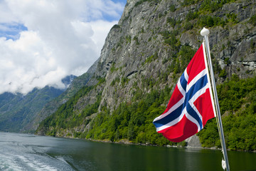 Norwegian flag waving in the fjords