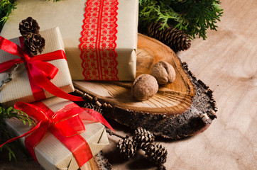 Christmas Presents in Rustic Style With Holiday Decorations. Xmas Composition on Wooden Background.