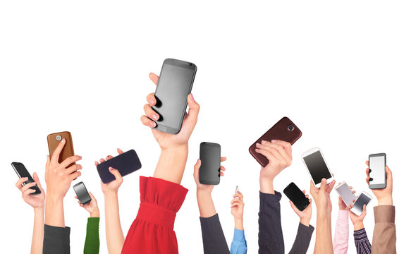 Many hands holding mobile phones on white background