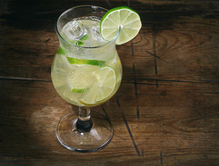 cocktail with lime, lemon, gin and ice cubes